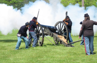 Confederat soldiers firing a cannon reenactment at Conecuh River Depot Military Museum.